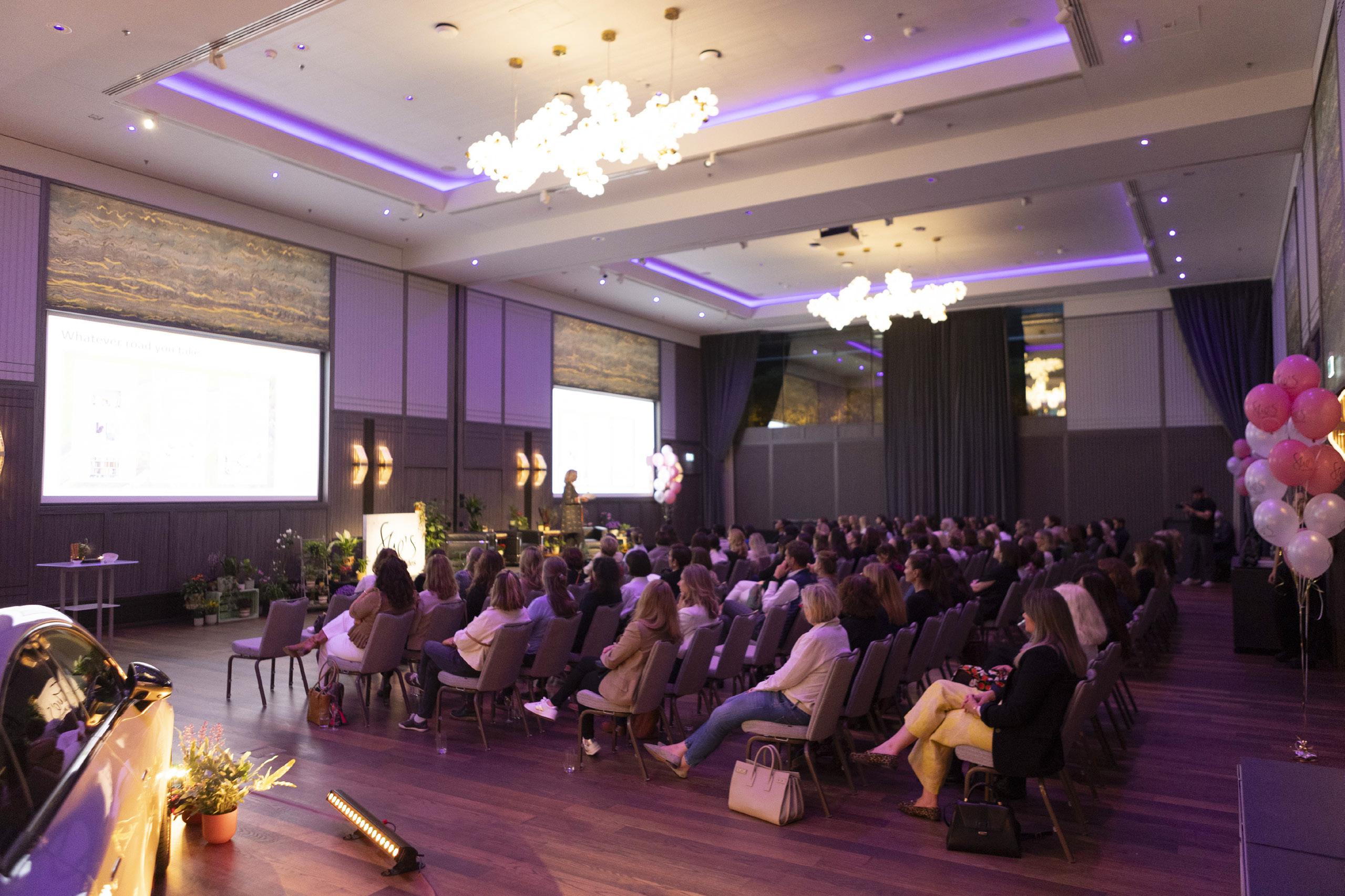 A large audience attending a workplace menopause event.
