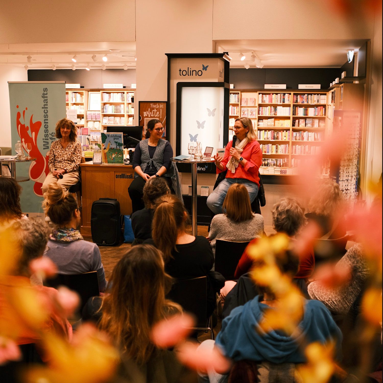 An interactive panel discussion in a bookshop with an audience.